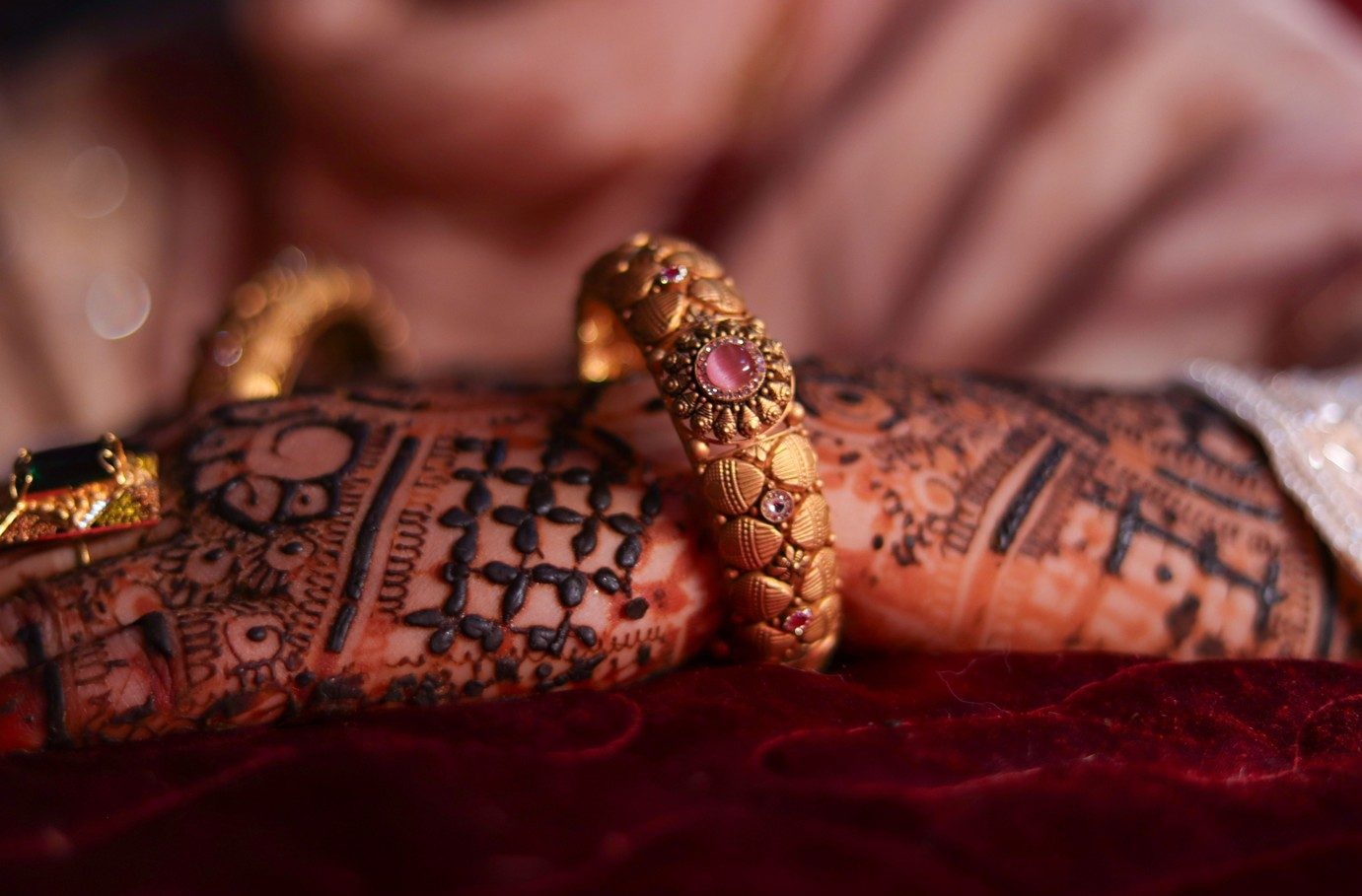 Antique gold bangles worn over bridal mehendi